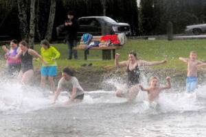 About 20 people took to the waters of Lake Pleasant on New Years morning at the Clallam County park during the Polar Bear plunge. (Lonnie Archibald/for Peninsula Daily News)
