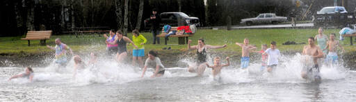 About 20 people took to the waters of Lake Pleasant on New Years morning at the Clallam County park during the Polar Bear plunge. (Lonnie Archibald/for Peninsula Daily News)