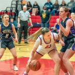 East Jefferson Teri Wiley battles for inside position against the defense of Sequims Hailey Wagner. Also in on the play is Sequims Kiley Winter. (Steve Mullensky/for Peninsula Daily News)