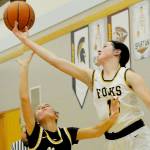 Chloe Gaydeski of Forks battles for a rebound over Ilwaco's Madison Smolorak on Monday in Forks. The Spartans won their Pacific 2B League opener 63-23. (Lonnie Archibald/for Peninsula Daily News)