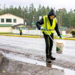 Phyllis Becker of Port Hadlock, foreground, and Wendy Davis of Port Townsend, volunteers with the Jefferson County Trash Task Force, pick up litter along Discovery Road on Sunday during the first trash pickup of the year. (Steve Mullensky/for Peninsula Daily News)