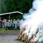 Members of Trail Life USA, a boys Christian adventure organization, salute the burning retired flags and holiday wreaths from veterans graves. This joint flag retirement and wreath burning ceremony took place Saturday at the Bekkevar farm in Blyn. (Emma Maple/Peninsula Daily News)