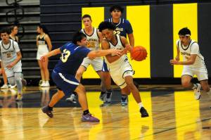 Lonnie Archibald/for Peninsula Daily News
Forks Bubba Hernandez-Stansbury drives around Chief Leschis Kevin Gallo-Paul Thursday night in Forks where The Spartans defeated the Warriors 84-23.