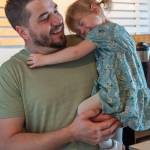 Rod Dirks enjoys affection from his 2-year-old daughter Maeli, who expresses confidence that doctors will heal her dads cancer. (Emily Matthiessen/Olympic Peninsula News Group)