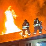 Clallam County Fire District 3 firefighters look to contain a fire in 2024. Calls for fires were down last year, but general calls for service were up from 2023. (Beau Sylte/Clallam County Fire District 3)