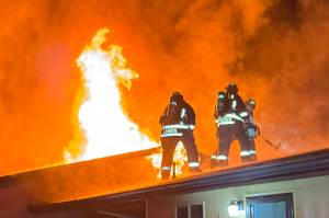 Clallam County Fire District 3 firefighters look to contain a fire in 2024. Calls for fires were down last year, but general calls for service were up from 2023. (Beau Sylte/Clallam County Fire District 3)