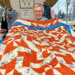 Matthew Nash/Olympic Peninsula News Group
LaRue Robirts shows one of the quilts she made for Toys for Sequim Kids on Dec. 17 at Sequim Prairie Grange. By her count, shes made and donated more than 1,400 quilts to community efforts.