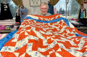 Matthew Nash/Olympic Peninsula News Group
LaRue Robirts shows one of the quilts she made for Toys for Sequim Kids on Dec. 17 at Sequim Prairie Grange. By her count, shes made and donated more than 1,400 quilts to community efforts.