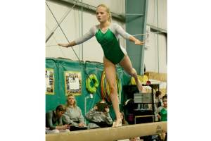 Port Angeles High School gymnast Mya Callis competes at the Port Angeles/Sequim home meet at the Klahhane Gymnastics center Monday. Bainbridge won the meet, while North Kitsap took second as the Spartans and Vikings are the top two gymnastics teams in the Olympic League. The combined Port Angeles/Sequim team took third. Lucy Spelker of the PA/Sequim team finished third in the floor exercie. Here, Port Angeles'  Mya Callis competes on the beam. The sub-district meet will be held Feb. 6. (Dave Logan/for Peninsula Daily News)