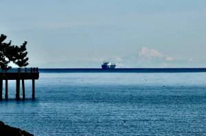 A ship passes by Mount Baker in the Strait of Juan de Fuca as seen from the Port Angeles City Pier on Wednesday morning. The weather forecast continues to be chilly this week as overnight temperatures are expected to hover around freezing. Daytime highs are expected to be in the mid-40s through the weekend. (Dave Logan/for Peninsula Daily News)