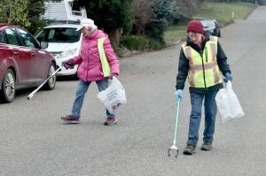 Dona Cloud and Kathy Estes, who call themselves the Garbage Grannies, volunteer each Wednesday to pick up trash near their neighborhood on the west side of Port Angeles. They have been friends for years and said they have been doing their part to keep the city clean for five years now. (Dave Logan/for Peninsula Daily News)