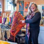 In her wet felting studio, Sequim artist Lora Armstrong explains how ruching happens in felt work. (Emily Matthiessen/Olympic Peninsula News Group)