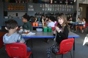 Kindergartener Zoey Griffin eats lunch with classmates in Amy Skogsbergs class. For most of Greywolf Elementarys history, students have eaten in their classrooms as the school was built without a dedicated cafeteria. A bond proposal includes building a cafeteria at the school, improving its parking lot and bus loop, and updating its air handler and heating units. (Matthew Nash/Olympic Peninsula News Group)