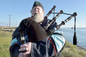 Erik Evans of Port Angeles, known as the Parking Lot Piper, performs on Tuesday at Sail and Paddle Park on Ediz Hook in Port Angeles. Evans often gives a free lunchtime concert on bagpipes at various locations in the Port Angeles area. (Keith Thorpe/Peninsula Daily News)