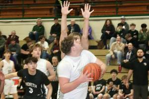 Port Angeles'  Brock Hope eyes the basket while being guarded by a North Kitsap defender Tuesday night in Port Angeles. Hope finished with 15 points and 15 rebounds as the Roughriders overcame a 14-point deficit to beat the Vikings. (Dave Logan/for Peninsula Daily News)