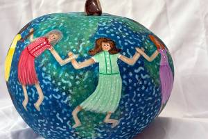 Jane Smith uses gourds as her canvas. She uses a wide variety of techniques and embellishments in her designs, and the trinkets she uses to enhance her work come from her lifetime of collecting.