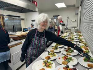 Kathy Cruz/Olympic Peninsula News Group
Mary Montgomery-Crumley dishes up helpings of salad at Soups On. Lunch also included a biscuit, two versions of minestrone soup, one vegetarian, one with chicken, and chocolate chip butterscotch bars.