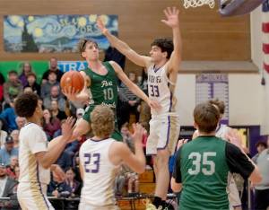 Port Angeles Keatyn Hoch (10) goes up for a basket against the defense of Sequims Jamison Gray (33) on Friday night in Sequim. The Wolves rallied in the fourth quarter to win 58-49. (Emily Mathiessen/Olympic Peninsula News Group)