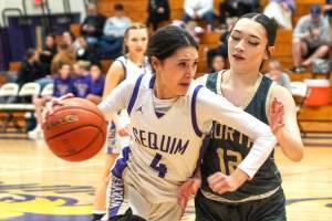 Sequims Gracie Chartraw dribbles against North Kitsap on Friday in the Wolves final home game of the year. (Emily Mathiessen/Olympic Peninsula News Group)