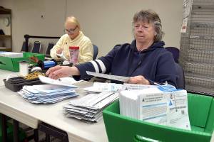 KEITH THORPE/PENINSULA DAILY NEWS
Clallam County election workers Neva Miller, right, and Debbie Kracht, both of Sequim, open election ballots on Tuesday at the courthouse in Port Angeles.