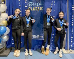 The Klahhane Xcel Gold team from left, includes Lainey DePiro, Raynee Ciarlo, Lorelei Sanders and Emily Bair. Four out of the six Xcel Gold members got 9.0 or higher in the floor exercise at the Realm Classic meet in Everett this weekend. (Klahhane Gymnastics)
