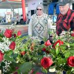 Fred Rix of Port Angeles, right, looks over floral arrangements with Ann ONeill, an employee of Angel Crest Gardens of Port Angeles at a temporary stand at First and Race streets in Port Angeles on Valentines Day. Rix said he wanted roses for his wife, Wendy Rix, for their 55th wedding anniversary. (Keith Thorpe/Peninsula Daily News)