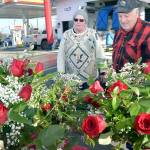 Fred Rix of Port Angeles, right, looks over floral arrangements with Ann ONeill, an employee of Angel Crest Gardens of Port Angeles at a temporary stand at First and Race streets in Port Angeles on Valentines Day. Rix said he wanted roses for his wife, Wendy Rix, for their 55th wedding anniversary. (Keith Thorpe/Peninsula Daily News)