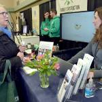 Cheryl Gertsch of Sequim, left, talks with Krista Meyers, project manager with Cascadia Solar of Port Townsend during the annual Home Building, Remodeling and Energy Expo on Saturday at Sequim Middle School. The event, hosted by the North Peninsula Building Association, featured a variety of booths, displays and presentations dedicated to home construction, repair and improvement. (Keith Thorpe/Peninsula Daily News)