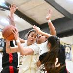 Peninsula College's Ryana Moss battles in the paint against Olympic's Allie Greene (2). Moss and Greene were teammates on Neah Bay's state championship team in 2023. (Jay Cline/Peninsula College)