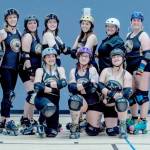 Sequim Gazette photo by Emily Matthiessen/ Port Scandalous Roller Derby league members pose for a group photo during a recent practice. Roller Derby athletes traditionally use special names when they play. Back row left to right: Big Papa, Lily Hammer, Skully, Small Fry, Sinna Buns, Steel MadNOLA, Summit Slayer and Austin Plowers. Kneeling: Elastigirl, Malice in Wonderland and Sarah Strange.