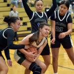 KEITH THORPE/PENINSULA DAILY NEWS Port Angeles Lindsay Smith, center, holds onto the ball surrounded by North Mason defenders, from left, Adrianna Tupolo, Adrianne Tupolo and Briana Cauhtenango on Tuesdays playoff game in Port Angeles.