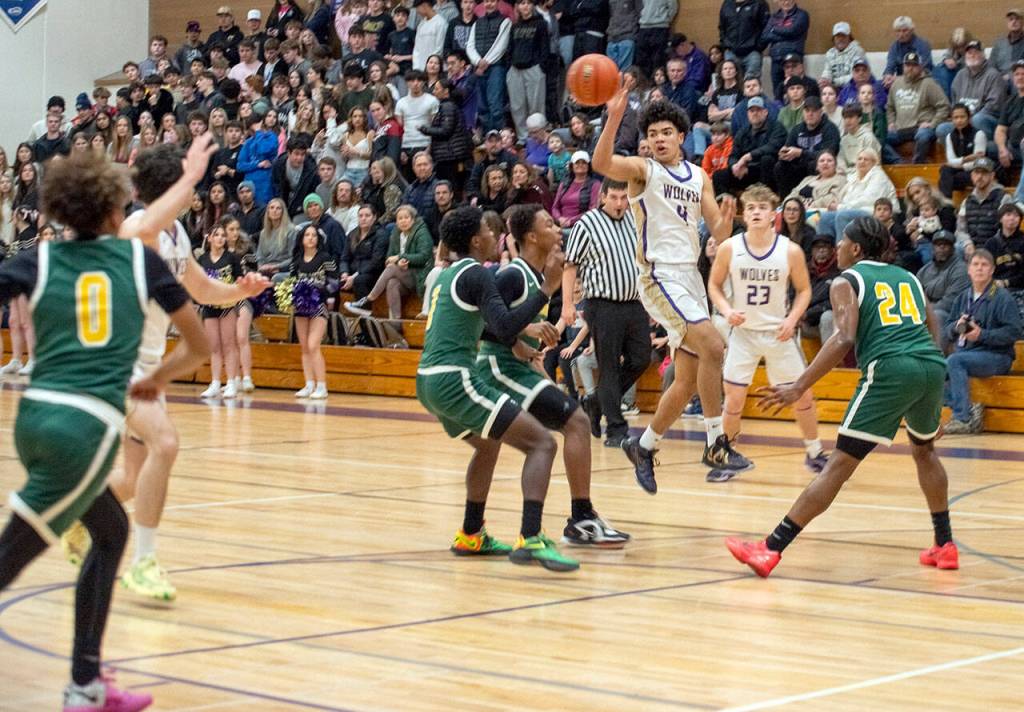 Emily Matthiessen/Olympic Peninsula News Group Sequim sophomore Jericho Julmist puts up a 3-point shot during the Wolves 76-50 Class 2A West Central District Boys Basketball Tournament victory Wednesday at Rick Kaps Gym.