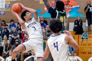 Sequims Solomon Sheppard goes up for a basket last week in a District 3 tournament game in Sequim against Foss. Sheppard had 14 points in a 56-46 win over Port Angeles on Saturday to help send the Wolves to the state tournament for the first time since 2012. In the foreground is Jericho Julmist (4). (Emily Mathiessen/Olympic Peninsula News Group)