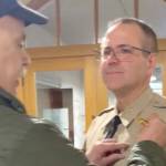 Retired Sheriff Joe Nole pinning interim Sheriff Andy Pernsteiners new badge on, following his appointment at the Jefferson County Courthouse.