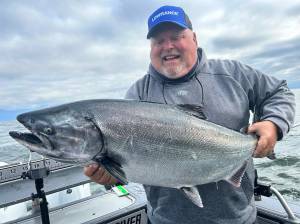 Roy angler John Keizer caught this chinook while fishing off the coast last summer. Salmon seasons negotiations are underway this month.