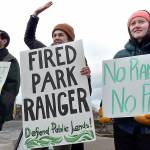 Hazel Galloway, a recently laid-off science communications specialist with the National Park Service, center, is flanked by Andy Marquez, a marine science student assisting Olympic National Park, left, and Mari Johnson, a supervisor with ONP partner Washington Conservation Corps during a protest at The Gateway in Port Angeles against the Trump administrations downsizing of the NPS workforce. (Keith Thorpe/Peninsula Daily News)