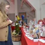 Sonja Elofson of Port Angeles examines a table of auction items during Fridays Red, Set Go! heart healthy luncheon at Vern Burton Community Center in Port Angeles. The event, hosted by the Olympic Medical Center Foundation and presented by Virginia Mason Franciscan Health, was designed to raise funds for the Olympic Medical Center Heart Center. (Keith Thorpe/Peninsula Daily News)