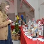 Sonja Elofson of Port Angeles examines a table of auction items during Fridays Red, Set Go! heart healthy luncheon at Vern Burton Community Center in Port Angeles. The event, hosted by the Olympic Medical Center Foundation and presented by Virginia Mason Franciscan Health, was designed to raise funds for the Olympic Medical Center Heart Center. (Keith Thorpe/Peninsula Daily News)