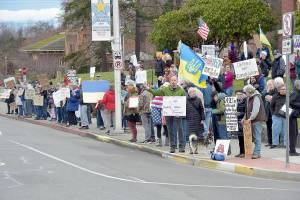 Demonstrators gather on the lawn of the Clallam County Courthouse on Tuesday in protest of the foreign and domestic policies of the Trump administration. Upwards of 100 people took part in the event. (Keith Thorpe/Peninsula Daily News)