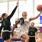 Peninsula Colleges Carliese OBrien drives to the hoop against Chemeketas Ava Rubio (4) and Mady Diaz (2) in the first round of the NWAC tournament at Columbia Basin College in Pasco. Peninsula got up 36-5 at the half and went on to win 66-44. (Jay Cline/Peninsula College)
