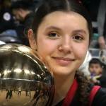 Neah Bays Qwaapeys Greene celebrates with the state championship trophy after the Neah Bay girls basketball team won its third straight state championship at Spokane Arena on Saturday afternoon. (NFHS Network)