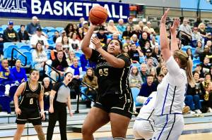 Peninsula College's Jelissa Julmist (Sequim High School) goes up for a basket against Lane in the NWAC semifinals held in Pasco on Saturday. Defending NWAC champion Lane hit 12 3-pointers and won 80-63, the Titans' 45th win in a row as the Pirates' season ends with a 24-3 record. In on the play is Peninsula's Ciera Tugade Agasiva. (Jay Cline/Peninsula College).