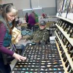 Jeannine Vaughn of Carlsborg looks a gems and jewelry at a display table operated by Steve Morgan of Joyce-based Lil Log Cabin Creations on Saturday at the Clallam County Rock, Gem and Jewelry Show at Vern Burton Community Center in Port Angeles. The show, hosted by the Clallam County Gem & Mineral Association, brought together rock enthusiasts with vendor booths and demonstrations highlighting the hobby. (Keith Thorpe/Peninsula Daily News)