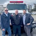 Port Executive Director Paul Jarkiewicz, left, City Fire Chief Derrell Sharp and Port Angeles City Manager Nathan West, right, pose in front of the citys newly purchased wildland urban interface fire engine. (City of Port Angeles)