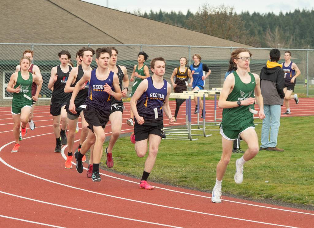 Emily Matthiessen/Olympic Peninsula News Group 
Port Angeles Easton Dempsey, front, leads a pack of runners from Sequim, East Jefferson, Port Angeles, Clallam Bay and Crescent during a track and field meet held Thursday in Sequim.