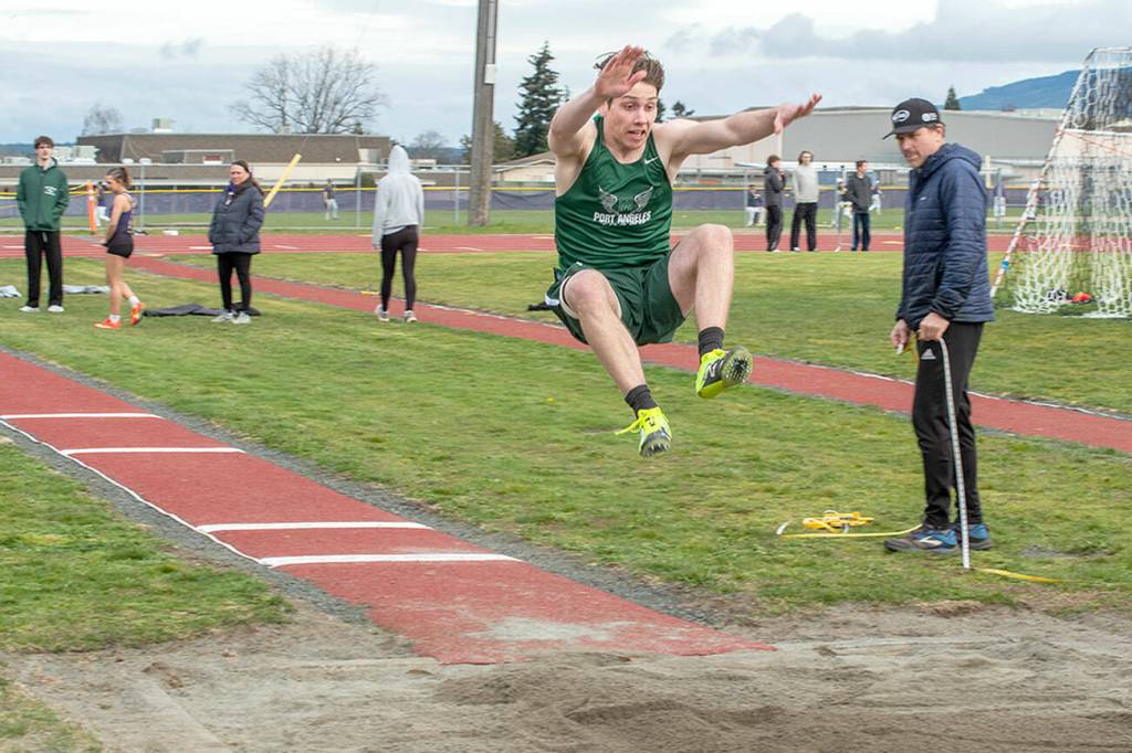 Emily Matthiessen/Olympic Peninsula News Group
Port Angeles' Richard Peterson competes in the long jump during a track and field meet held at Sequim High School on Thursday.