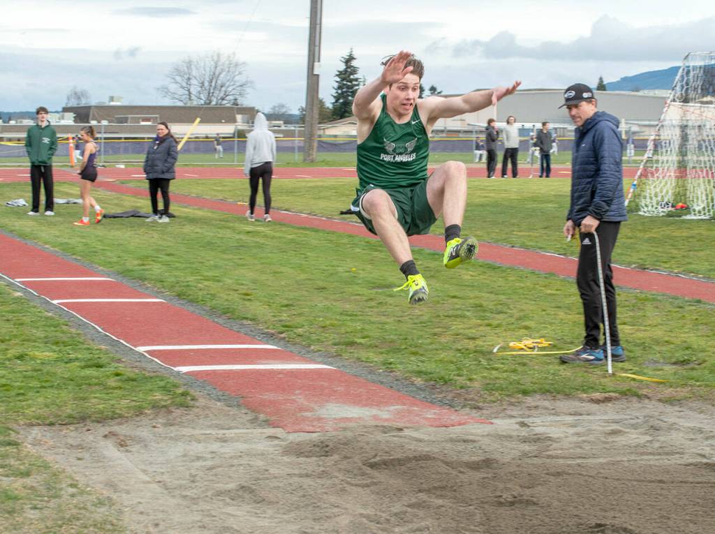 Emily Matthiessen/Olympic Peninsula News Group Port Angeles Richard Peterson competes in the long jump during a track and field meet held at Sequim High School on Thursday.
