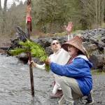 Lummi Nation member Freddie Lane, whose tribal name is Sul Ka Dub, left, and tribal elder Richard Solomon, known as Hutch Ak Wilton, kneel along the banks of the Elwha River in Olympic National Park on Friday to ceremonially ask permission to be at the river in preparation for World Water Day festivities in Port Angeles. Lane, along with members of the Lower Elwha Klallam Tribe, will take part in an opening ceremony at 11 a.m. today at Hollywood Beach, followed by an interfaith water blessing at nearby Pebble Beach Park. Other World Water Day activities include guided nature hikes, environmentally themed films at the Little Theater at Peninsula College and a performance by Grammy Award-winning indigenous artist Star Nayea. (Keith Thorpe/Peninsula Daily News)