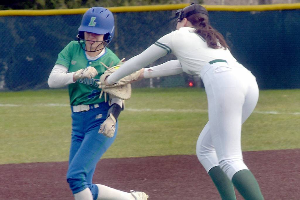 KEITH THORPE/PENINSULA DAILY NEWS
Port Angeles first baseman Lexie Smith, right, chases down Liberty's Izzy Pockey for a tag between first and second on Friday at Volunteer Field.