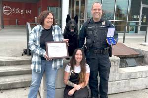 Matthew Nash/Olympic Peninsula News Group
Mamba sits at the Sequim Civic Center with her family  Sequim Police Officer Paul Dailidenas, his wife Linda, left, and their daughter Alyssa on March 10 after Dailidenas and Mamba received a Distinguished Medal. Mamba retired from service after nearly eight years, and Sequim is training another officer and dog to take over the K-9 Officer Program with Dailidenas blessing.